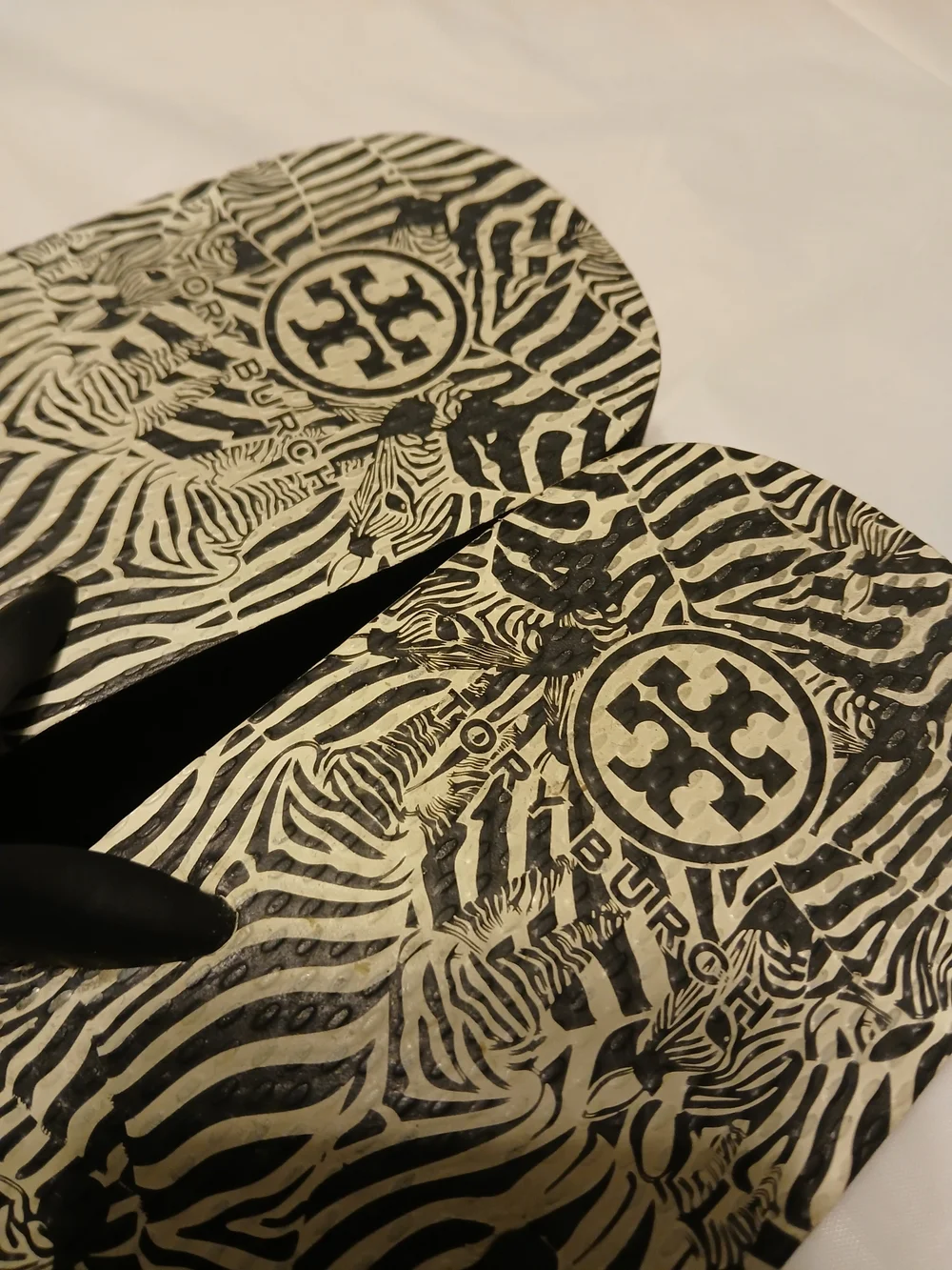 Tory Burch Ladies Black Zebra Flip Flops with Gold Logo